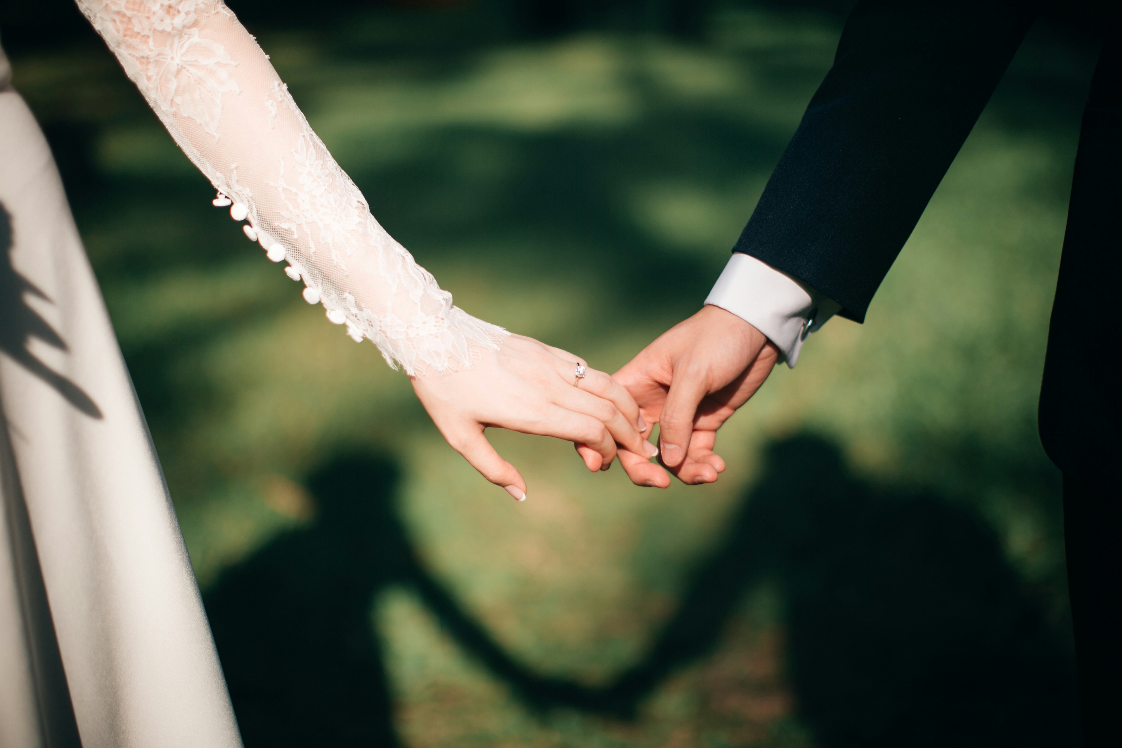 Wedding couple holding hands - romantic moment